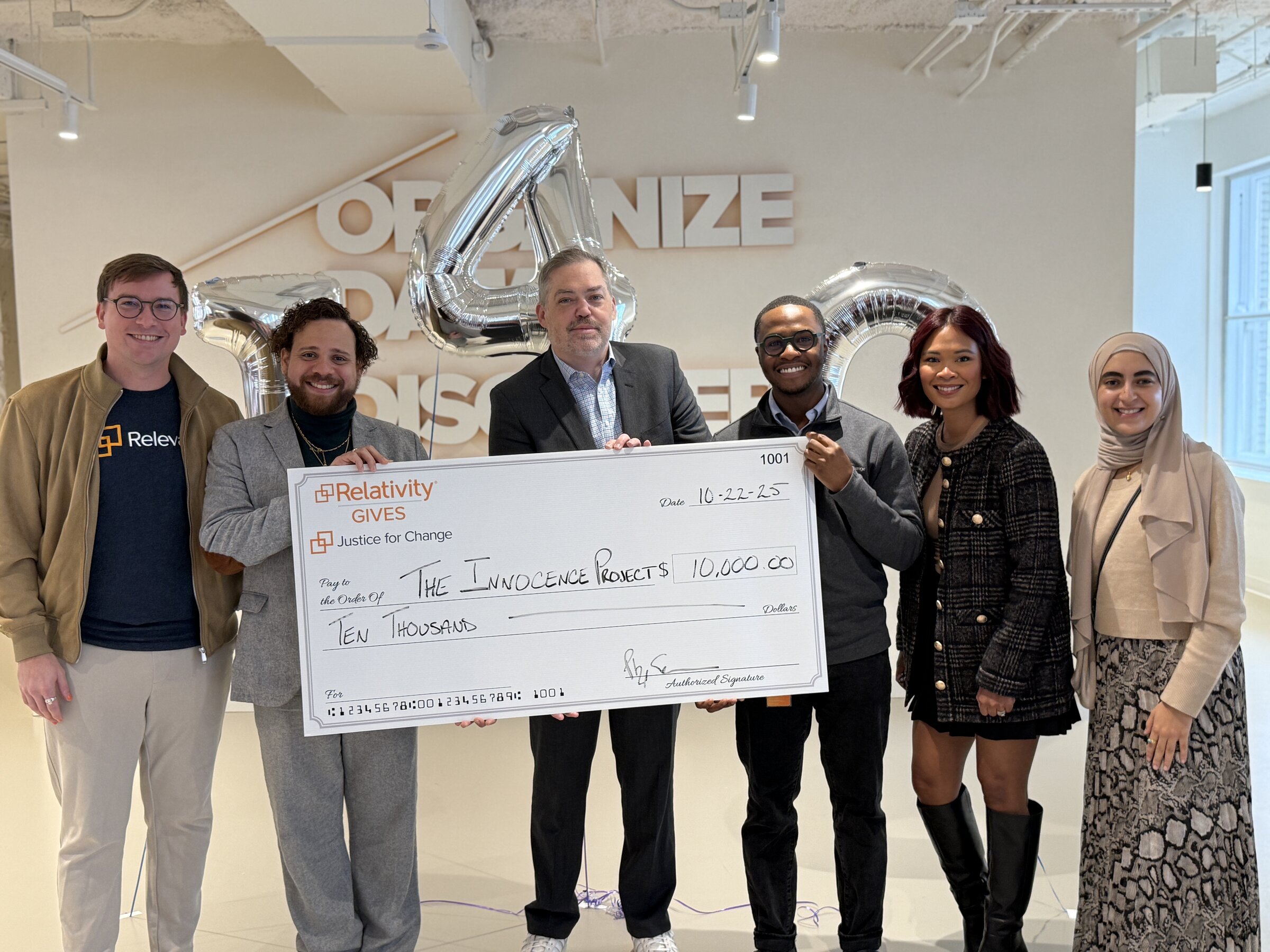 Innocence Project Donation group photo with check